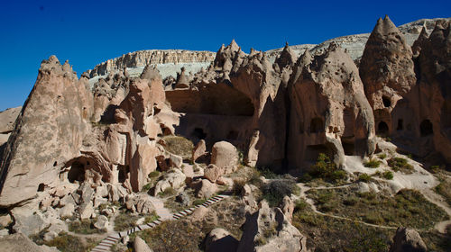 Low angle view of rocks on mountain against sky