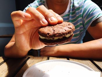Midsection of man holding food at table