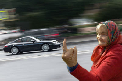 Blurred motion of man riding bicycle on road