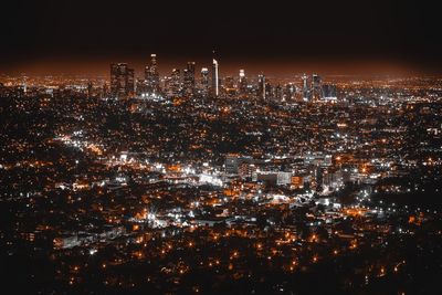 Aerial view of illuminated cityscape against sky at night