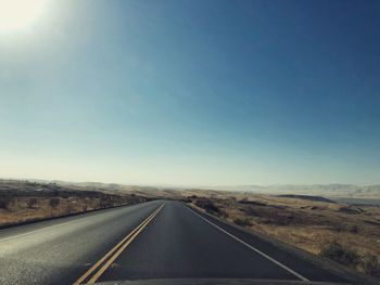 Country road against clear sky