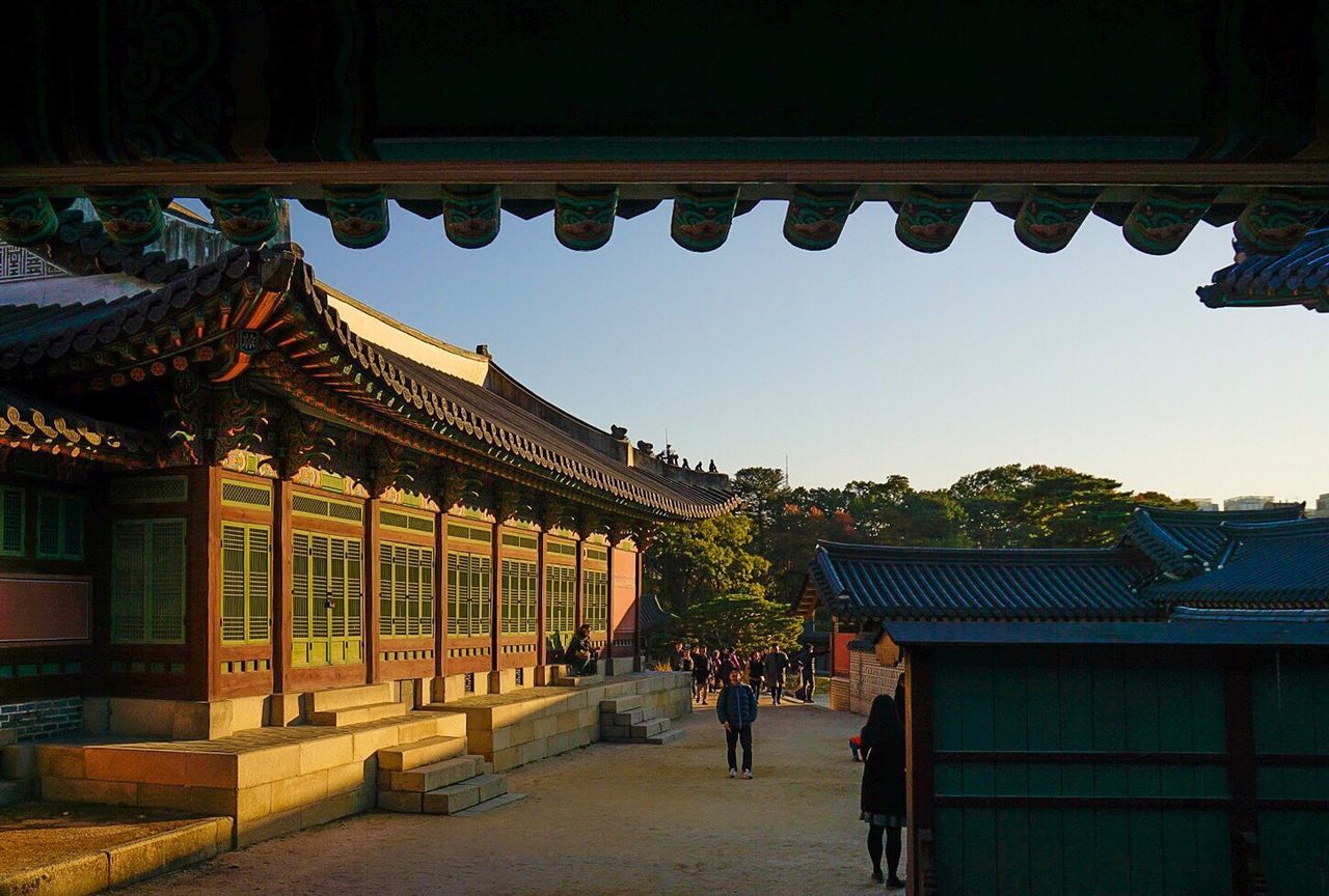 PEOPLE IN FRONT OF BUILT STRUCTURE