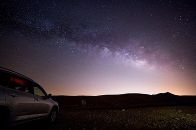 Scenic view of landscape against sky at night