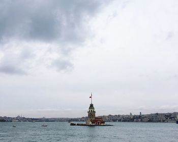 Building amidst sea against sky