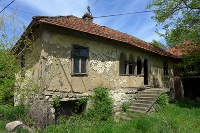 Low angle view of abandoned building against sky