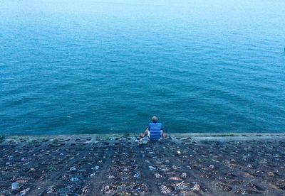 High angle view of man sitting in sea