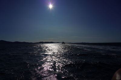Scenic view of sea against clear sky on sunny day