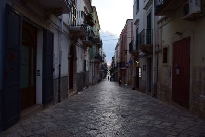 Narrow street amidst buildings in city