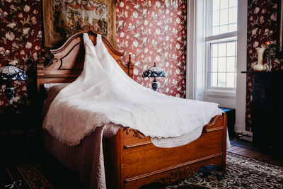 Wedding dress on bed at home