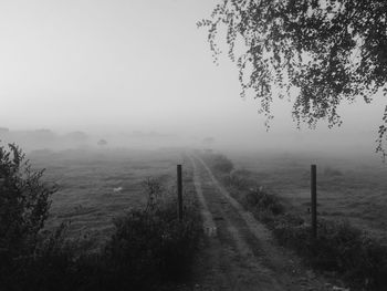 Scenic view of landscape against sky during foggy weather