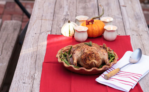 High angle view of roast chicken in container on table