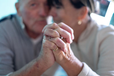 Close-up of senior man holding hands