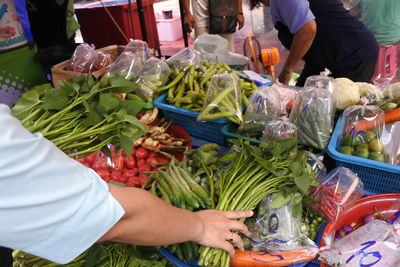 Midsection of people at market stall