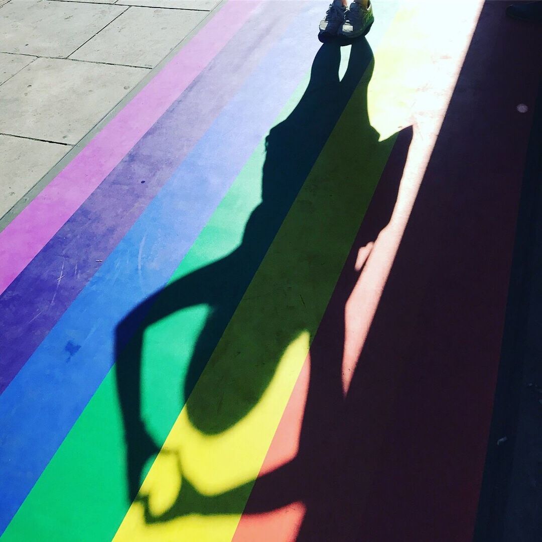 CLOSE-UP OF MULTI COLORED SHADOW ON THE GROUND