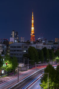 High angle view of light trails on road against buildings