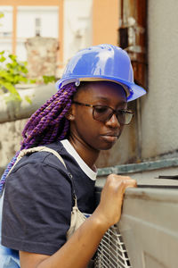 Portrait of young man standing in city