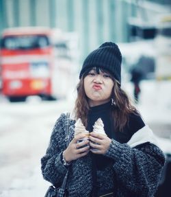 Beautiful woman standing in city during winter