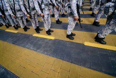 Low section of soldiers standing in row in city