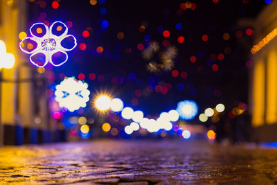 Defocused image of illuminated christmas lights at night
