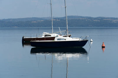 Boats sailing in sea against sky