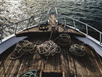 Low angle view of rope tied to pole against sea