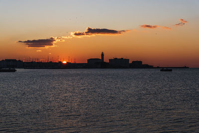 Sunset from the audace pier of trieste. colors of fire on the water. italy