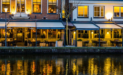 Buildings by river at night