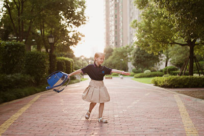 Full length of boy on street in city