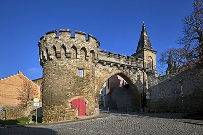 Low angle view of historical building against clear blue sky