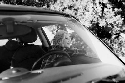 Portrait of woman sitting in car