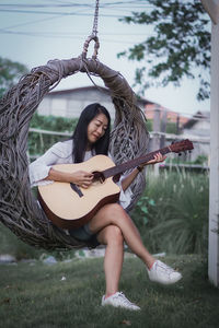 Young woman playing guitar