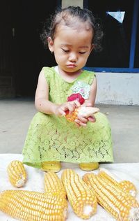 Cute baby girl sitting on table