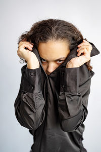 Young woman wearing sunglasses against white background