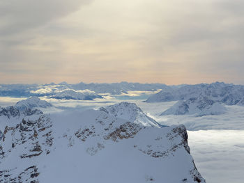Scenic view of snowcapped mountains against sky during sunset