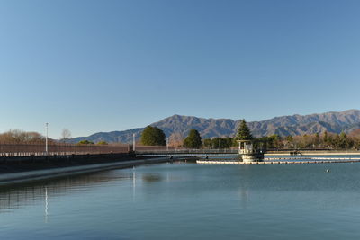 Scenic view of lake against clear blue sky