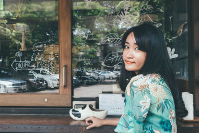 Portrait of woman looking at camera