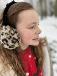 Smiling girl looking away during winter