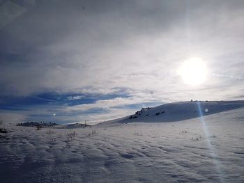 Scenic view of snowy landscape against sky 