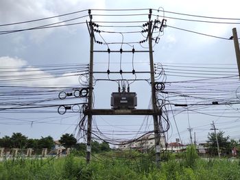 Low angle view of electricity pylon against sky