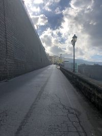 Empty road along buildings