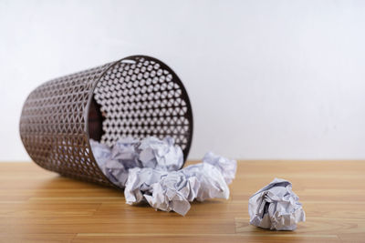 Close-up of garbage on table against white background