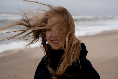 Portrait of smiling young woman at beach