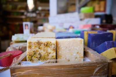 Craft multi-colored natural organic soap bars at shop shelf. traditional soap manufacture