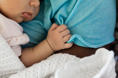 Close-up of baby boy sleeping on bed