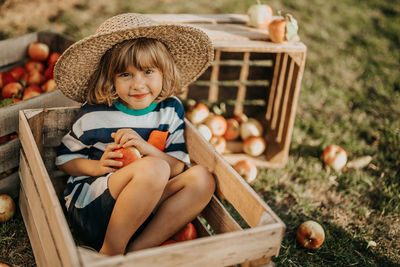 Portrait of cute girl sitting on field