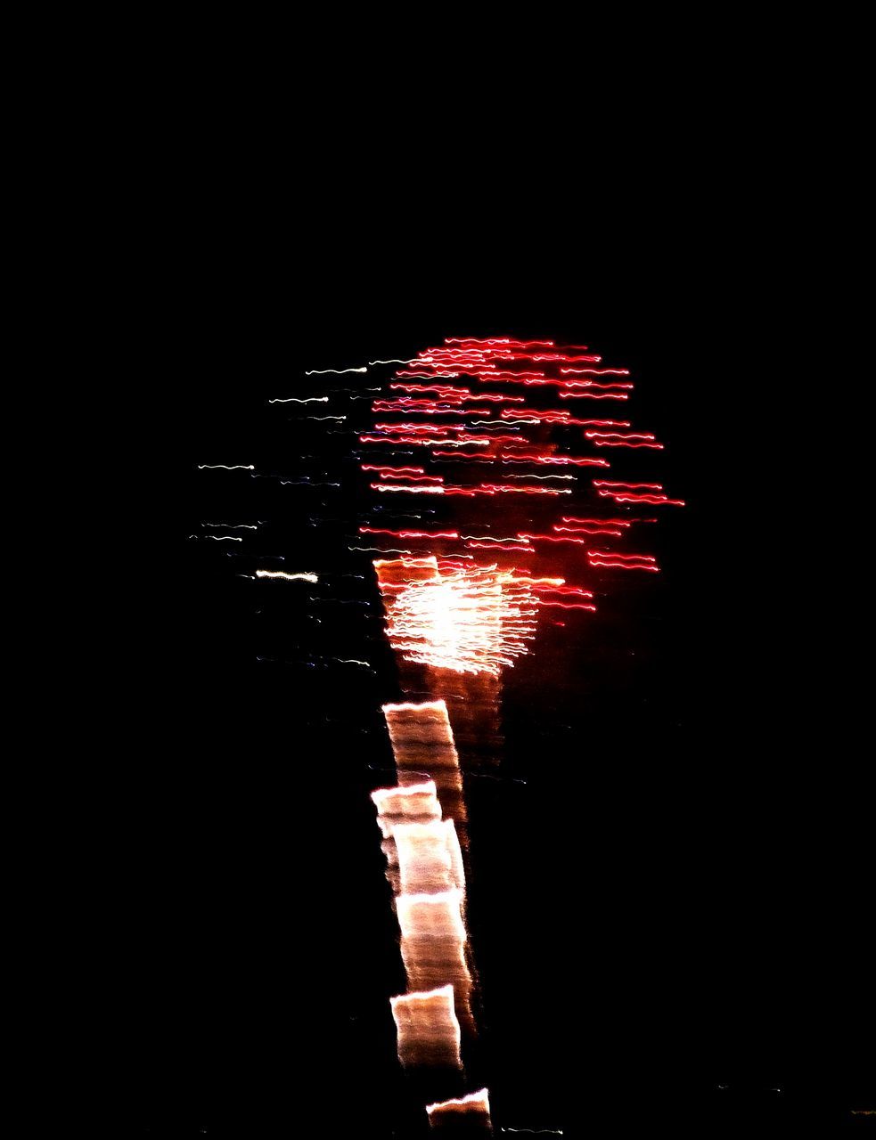 night, illuminated, glowing, red, low angle view, dark, arts culture and entertainment, motion, lighting equipment, lit, no people, light, black background, outdoors, firework, sky, close-up