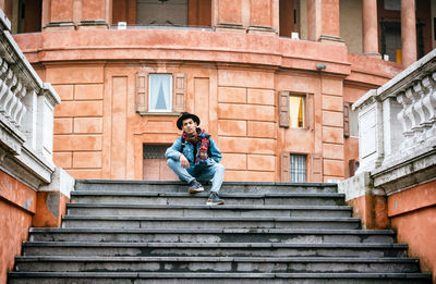 Full length of woman standing on steps