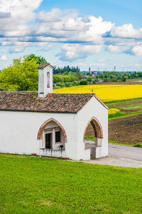 Built structure on field against sky