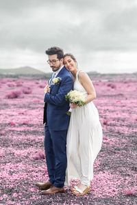 Portrait of smiling couple standing on field