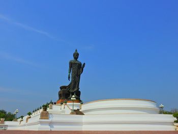 Low angle view of statue against clear blue sky